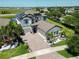 Stunning home with a three-car garage, paved driveway, and lush tropical landscaping at 13103 Monach Isles Dr, Riverview, FL 33579