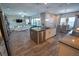 Open-concept kitchen includes an island with sink and seating and connects to a dining and living area at 13103 Monach Isles Dr, Riverview, FL 33579