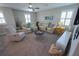 Cozy living room featuring comfortable seating, a ceiling fan, and natural light at 13103 Monach Isles Dr, Riverview, FL 33579