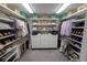 Spacious walk-in closet with custom shelving, drawers, and ample storage for clothes and accessories at 13103 Monach Isles Dr, Riverview, FL 33579