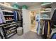 Walk-in closet that features extensive storage for clothing and accessories adjacent to the main bathroom at 13103 Monach Isles Dr, Riverview, FL 33579