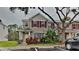 Charming townhome featuring red shutters, tasteful landscaping, and a welcoming entrance at 13640 Forest Lake Dr, Largo, FL 33771