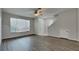 Inviting living room featuring hardwood flooring, neutral paint, and updated ceiling fan at 13640 Forest Lake Dr, Largo, FL 33771