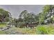 Scenic pond view surrounded by lush greenery, tall trees, and rock edging at 13640 Forest Lake Dr, Largo, FL 33771