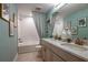 This bathroom features a tub/shower combination, framed artwork, and double vanity at 13722 Heartwood Way, Parrish, FL 34219