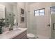 Bright bathroom showcasing a white tiled shower with glass door and vanity with stylish hardware at 13722 Heartwood Way, Parrish, FL 34219