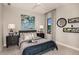 Cozy bedroom with a blue accent bed, matching nightstands, and decorative wall art and window at 13722 Heartwood Way, Parrish, FL 34219