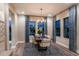 Dining room with elegant lighting fixture, neutral-toned furnishings, and large windows overlooking a scenic outdoor view at 13722 Heartwood Way, Parrish, FL 34219