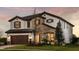 Charming two-story home with stone accents, a tile roof, manicured lawn and a convenient 2-car garage at 13722 Heartwood Way, Parrish, FL 34219