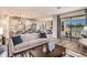 Open-concept living room flowing into kitchen, with wood floors and glass doors leading to an outdoor patio at 13722 Heartwood Way, Parrish, FL 34219