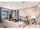 Bright living room with stylish furnishings, modern decor, and sliding glass doors offering scenic views at 13722 Heartwood Way, Parrish, FL 34219
