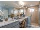 The main bathroom has double sinks, vanity, shower, and neutral tile for a modern look at 13722 Heartwood Way, Parrish, FL 34219
