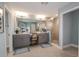 A spacious main bathroom boasts double sinks, a vanity, and a glass-enclosed shower for a luxurious feel at 13722 Heartwood Way, Parrish, FL 34219