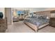 This main bedroom features a seating area with views and a large bed with accent pillows at 13722 Heartwood Way, Parrish, FL 34219