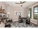 Well-lit office space with a modern desk, stylish chairs, and decorative shelving at 13722 Heartwood Way, Parrish, FL 34219