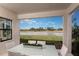 Covered patio with outdoor seating, offering beautiful lake views and a tranquil setting at 13722 Heartwood Way, Parrish, FL 34219