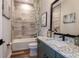 Bathroom featuring decorative tile floor, granite countertop, and shower with patterned curtain at 13726 Heartwood Way, Parrish, FL 34219