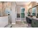 Modern bathroom with a walk-in shower, dual sinks, and plenty of storage at 13726 Heartwood Way, Parrish, FL 34219