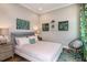 Cozy bedroom with accent wall art, pendant chair, and soft natural lighting at 13726 Heartwood Way, Parrish, FL 34219