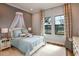 Light-filled bedroom featuring soft blue bedding, neutral walls, and bright windows at 13726 Heartwood Way, Parrish, FL 34219