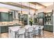 Spacious modern kitchen featuring wooden beams, a large island, and stainless steel appliances at 13726 Heartwood Way, Parrish, FL 34219