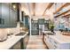 Bright and modern kitchen featuring wood beams, large island, and stainless steel appliances at 13726 Heartwood Way, Parrish, FL 34219