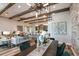 Open concept living area with exposed beams, modern lighting, and seamless flow to the kitchen at 13726 Heartwood Way, Parrish, FL 34219