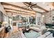 Open-concept living room and kitchen with wood beam ceilings and stylish decor at 13726 Heartwood Way, Parrish, FL 34219