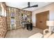 Inviting home office featuring a brick accent wall, neutral decor and fan at 13726 Heartwood Way, Parrish, FL 34219