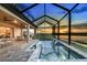 Stunning screened-in pool area with lake view and water features, perfect for relaxation at 13726 Heartwood Way, Parrish, FL 34219