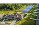 Aerial view of the property with fenced backyard, lush trees, and a nearby lake at 14560 Haddon Mist Dr, Wimauma, FL 33598