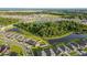 Wide aerial view showing the community with lakes, greenery, and well-maintained homes at 14560 Haddon Mist Dr, Wimauma, FL 33598
