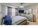 This bedroom features a large bed, dresser, and closet at 14560 Haddon Mist Dr, Wimauma, FL 33598
