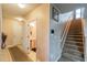 Inviting foyer with staircase, half-bathroom and tile flooring at 14560 Haddon Mist Dr, Wimauma, FL 33598