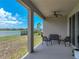 This is a back porch with outdoor seating and serene lake views; perfect for relaxation at 152 Bright Ibis Ave, Apollo Beach, FL 33572