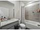 This bathroom features a shower-tub combo, a gray vanity, neutral paint, and decorative accents at 152 Bright Ibis Ave, Apollo Beach, FL 33572
