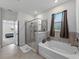 Spa-like bathroom with tiled shower, soaking tub, and a luxurious feel at 152 Bright Ibis Ave, Apollo Beach, FL 33572