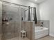 Modern bathroom with glass shower and soaking tub at 152 Bright Ibis Ave, Apollo Beach, FL 33572