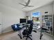 This is a bright office/bedroom featuring a large desk, shelving, and a lovely bright window at 152 Bright Ibis Ave, Apollo Beach, FL 33572