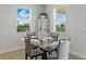 Dining room featuring a modern glass table and serene outdoor views at 152 Bright Ibis Ave, Apollo Beach, FL 33572