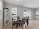 Elegant dining area with glass table and display cabinet near sliding doors at 152 Bright Ibis Ave, Apollo Beach, FL 33572