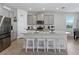 Open kitchen features an island, grey cabinetry, stainless steel appliances, and recessed lighting at 152 Bright Ibis Ave, Apollo Beach, FL 33572