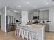 The well-lit open kitchen features stainless steel appliances, an island, and tiled flooring at 152 Bright Ibis Ave, Apollo Beach, FL 33572