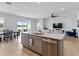 Open floor plan with a well-equipped kitchen and barstool seating overlooking the living area at 152 Bright Ibis Ave, Apollo Beach, FL 33572