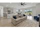 Open-concept living area featuring modern gray kitchen, dining space, and sliding doors to patio at 152 Bright Ibis Ave, Apollo Beach, FL 33572