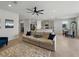 Comfortable living room with neutral tones, tile flooring, and an open layout at 152 Bright Ibis Ave, Apollo Beach, FL 33572