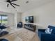 Cozy living room with plush seating, large TV, and view to outdoor space at 152 Bright Ibis Ave, Apollo Beach, FL 33572