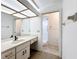 Bright bathroom with a large vanity, full mirror, and glass-enclosed shower at 1556 Lynda Ln, Dunedin, FL 34698