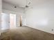 This bedroom features neutral walls and carpet, with ensuite bath access at 1556 Lynda Ln, Dunedin, FL 34698