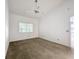 Neutral bedroom featuring ceiling fan and sun-filled window at 1556 Lynda Ln, Dunedin, FL 34698